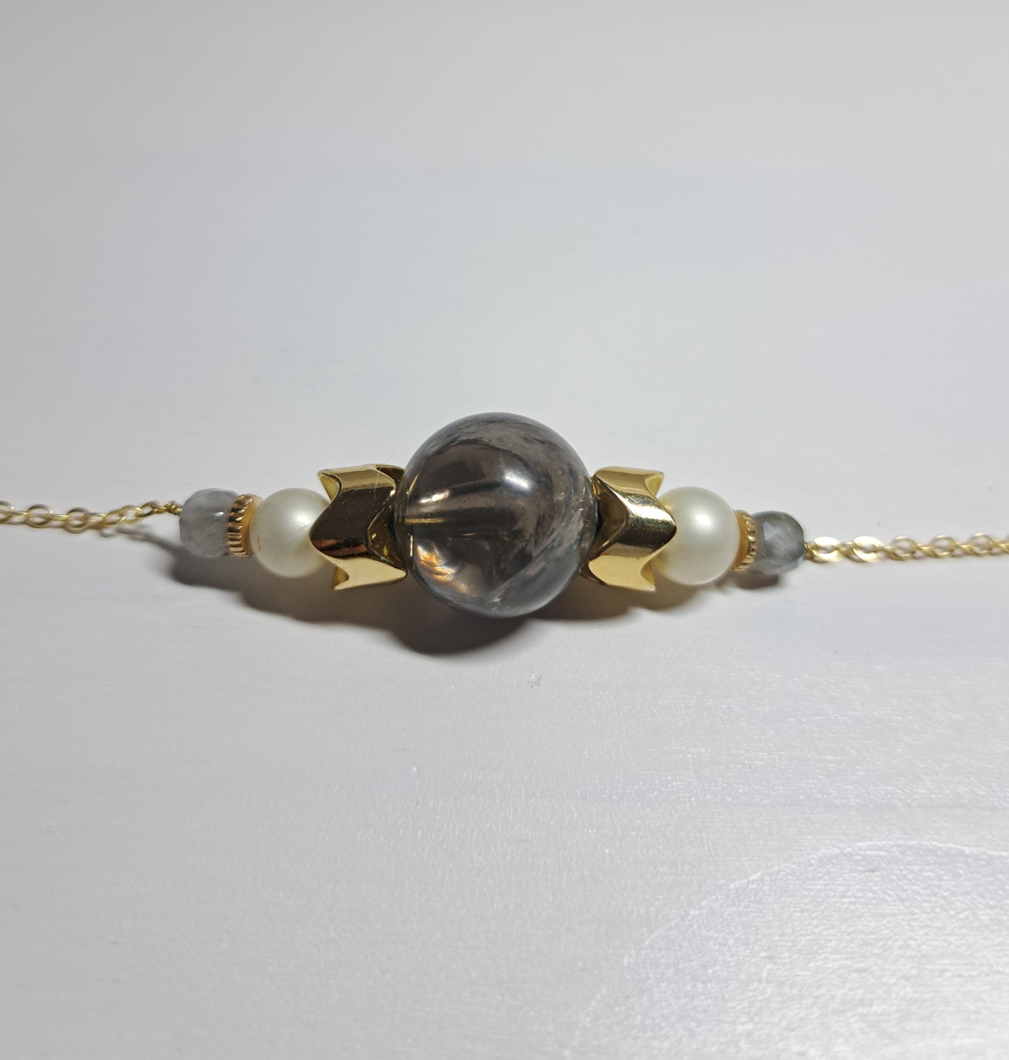 Second-hand gray and gold bracelet